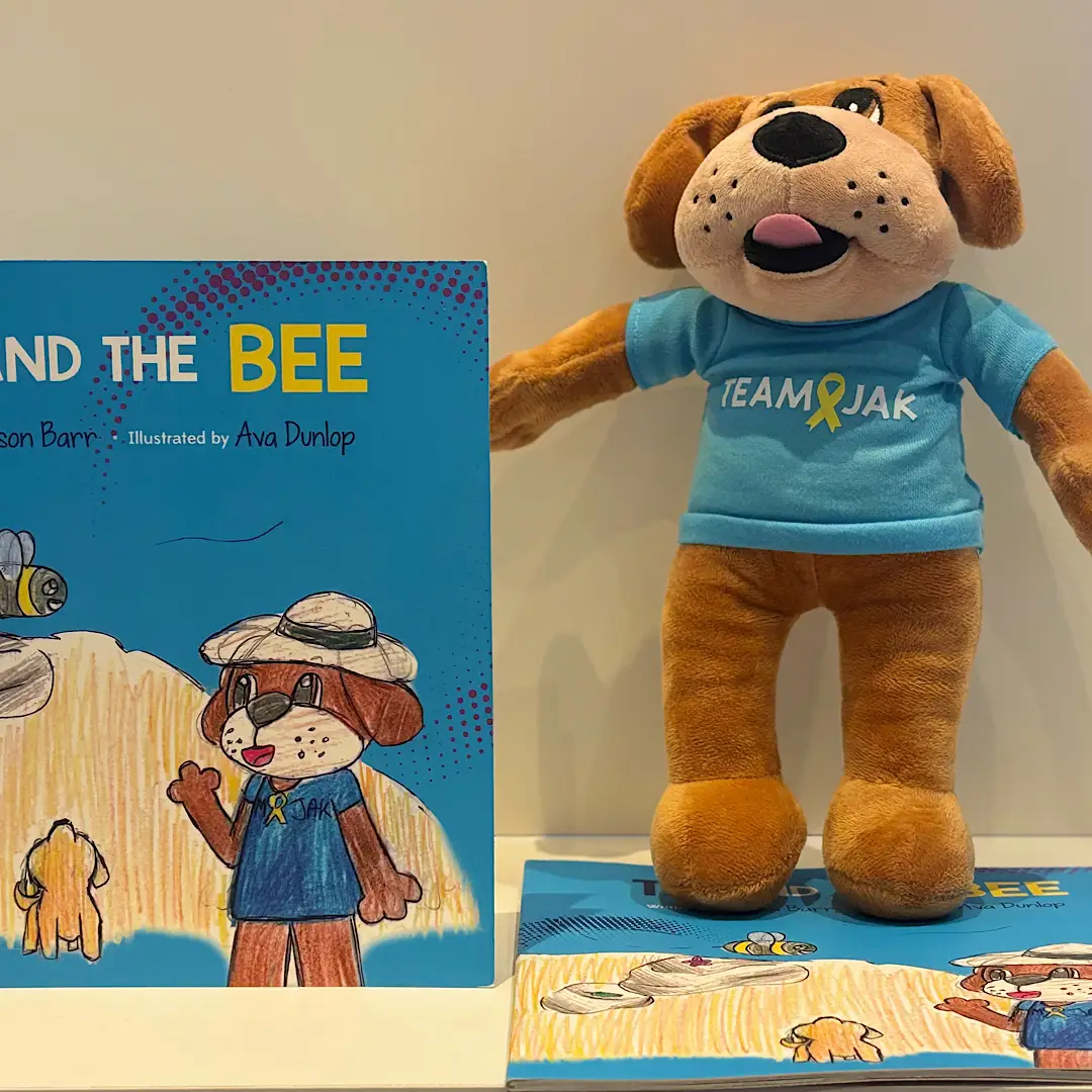 Team Jak's TJ and the Bee Book follows dog mascot TJ's journey with a very special bee by his side. Available alone or with a TJ plush toy.